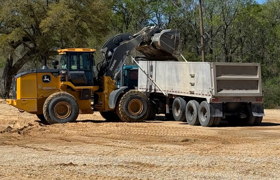 A wheel loader filling a dump trailer with material at one of our Louisiana mining operations